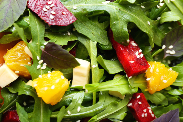 Tasty salad with arugula leaves, closeup